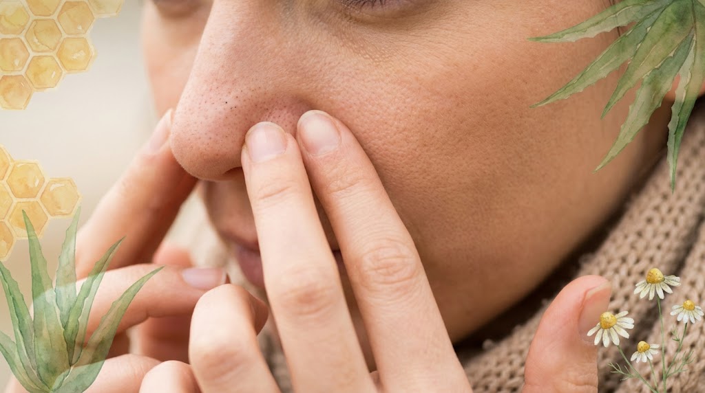 Close-up of a woman's nose with visible natural blackheads, surrounded by illustrations of gentle natural skincare ingredients such as aloe vera, honey, and chamomile.